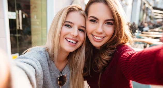 Two women enjoying the benefits of cosmetic dentistry