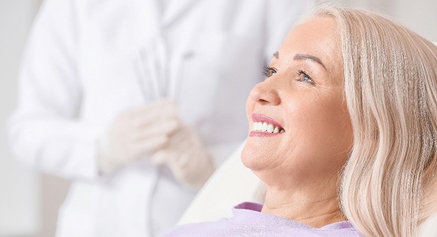 woman smiling after getting CEREC crown