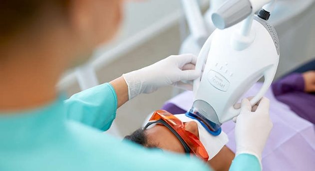 Dental patient receiving zoom teeth whitening treatment