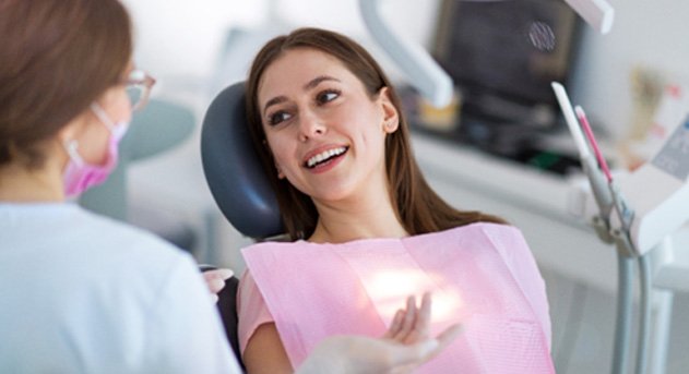 A dentist talking with her patient